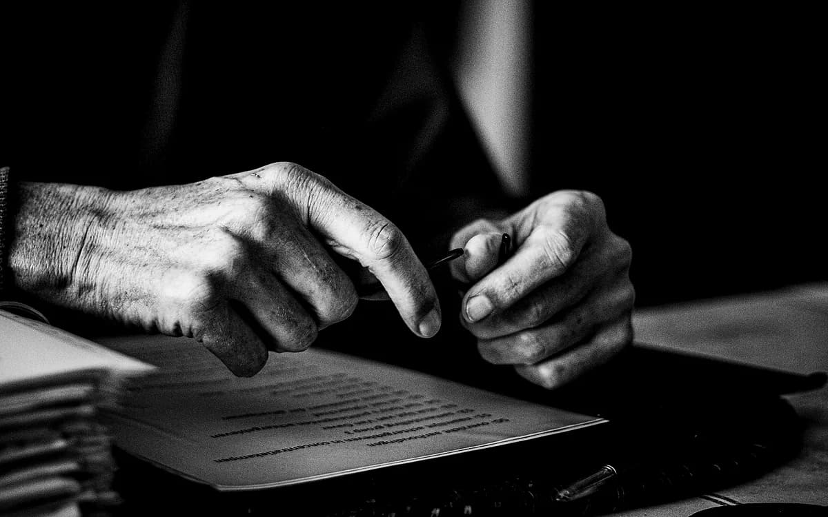Close detail of hands reviewing a printed document