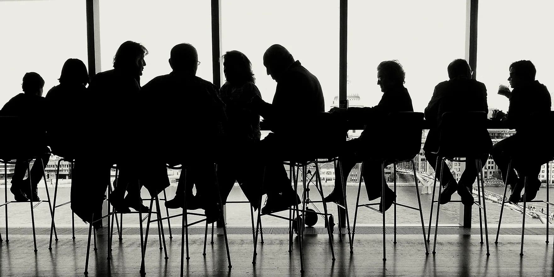 A leadership session in progress, seen in silhouette against a window